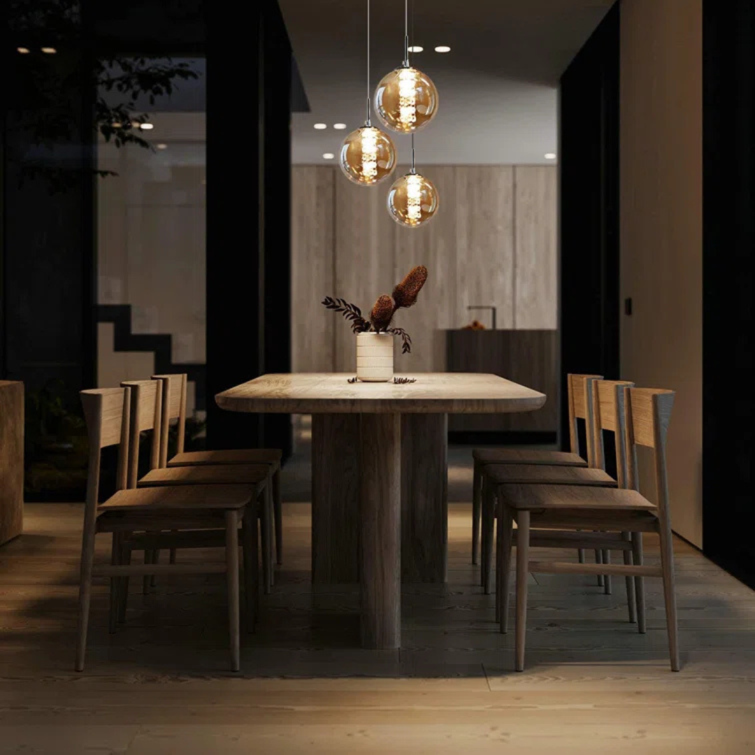 Dining area with wooden table and chairs in a dimly lit room