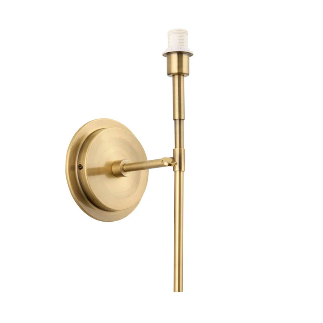 Gold wall-mounted light fixture on a white background