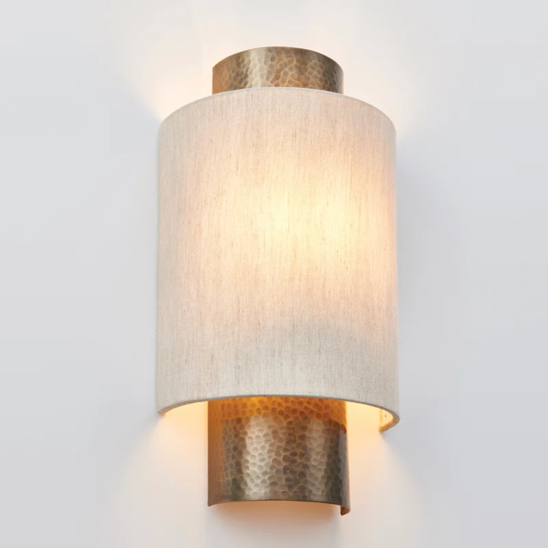 Wall-mounted light fixture with textured design on a white background