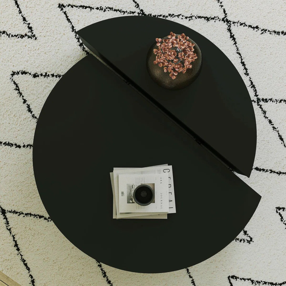 Contemporary low round coffee table with magazine slot, black table, top view.