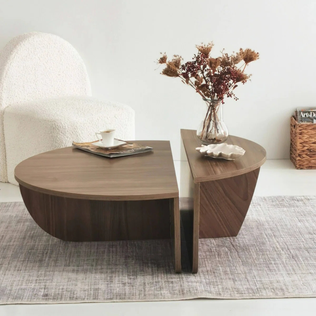 Contemporary low round coffee table with magazine slot, brown table set in a modern home, side view.