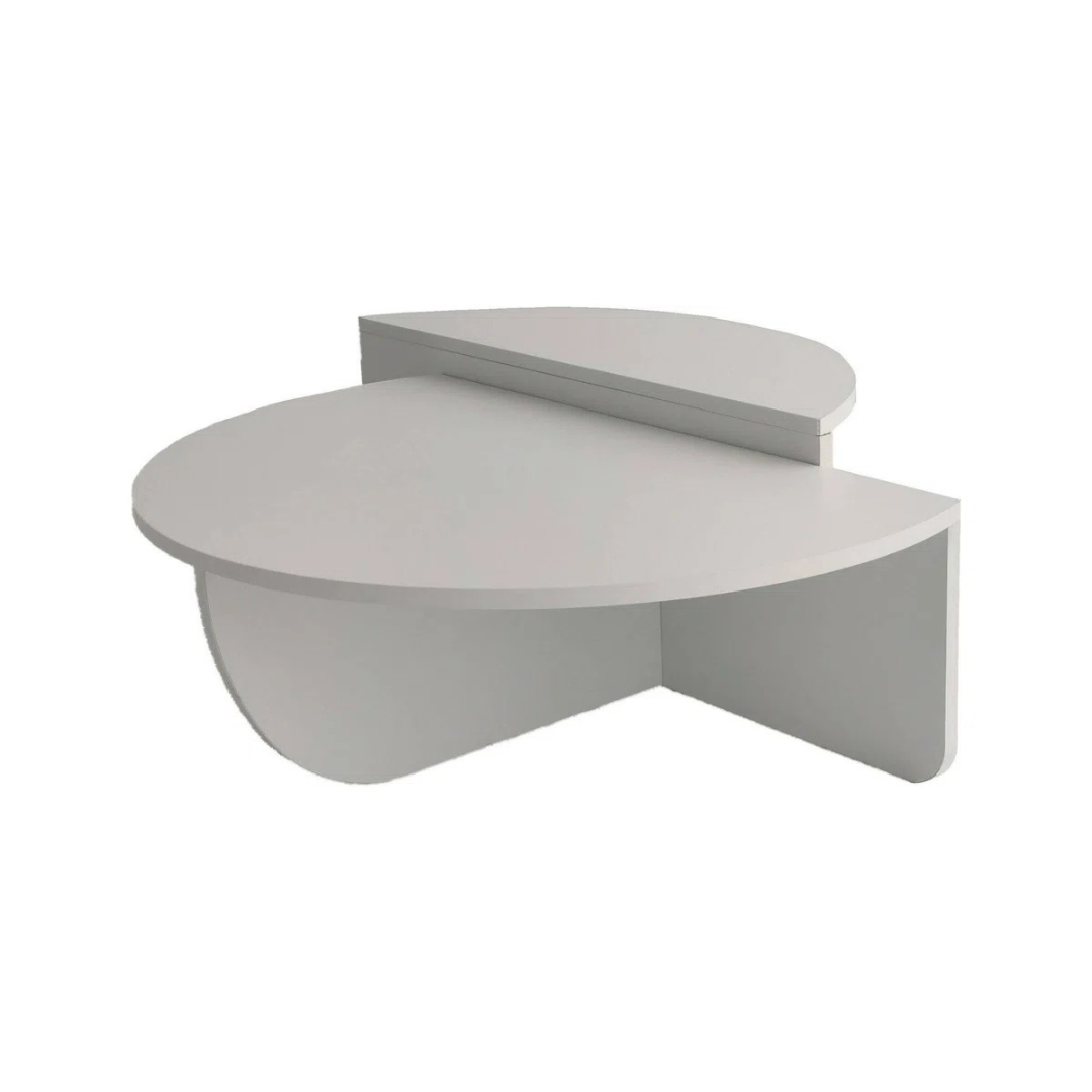 Contemporary low round coffee table with magazine slot, white table with a white background.
