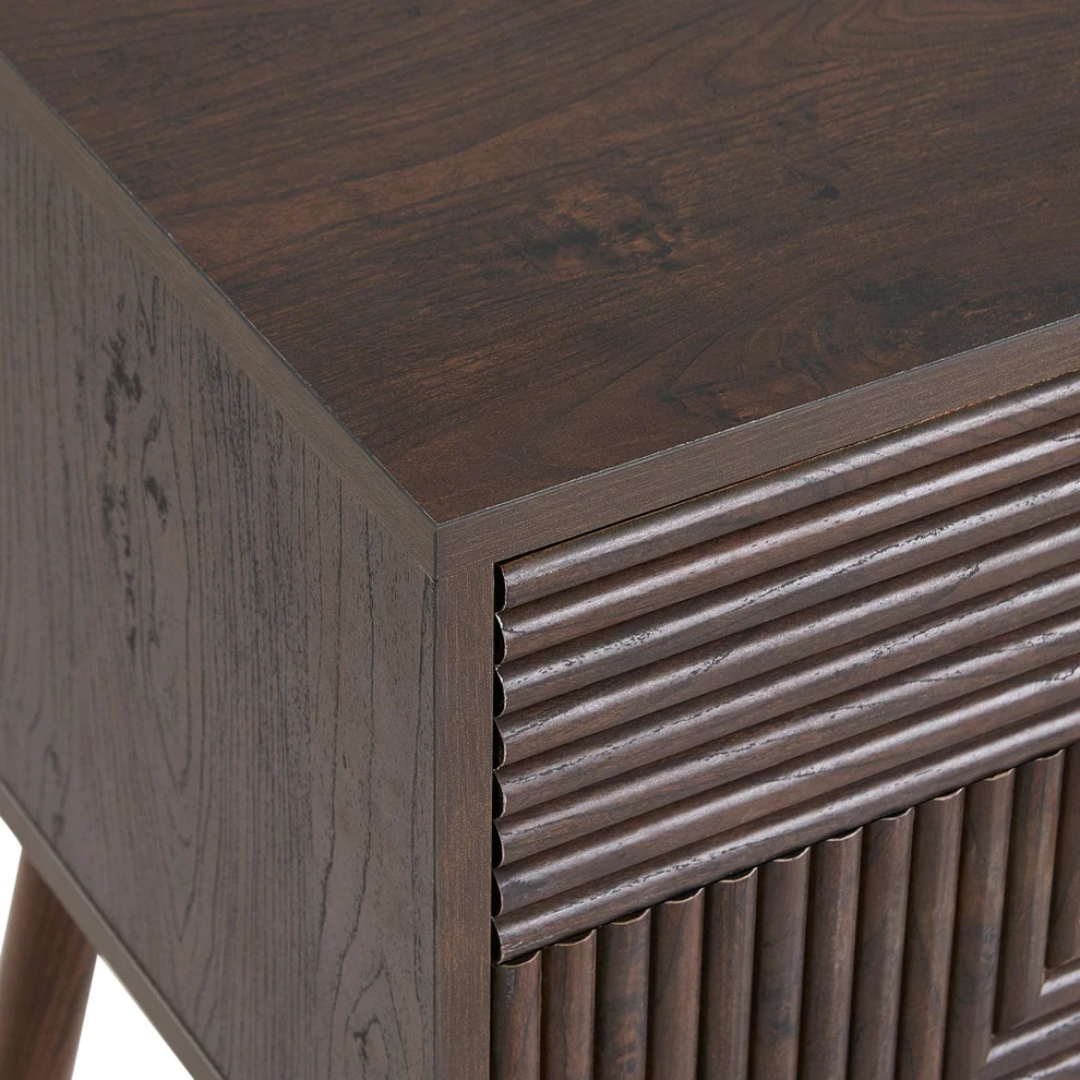 Close-up of a wooden side table with a textured surface and geometric design. close up