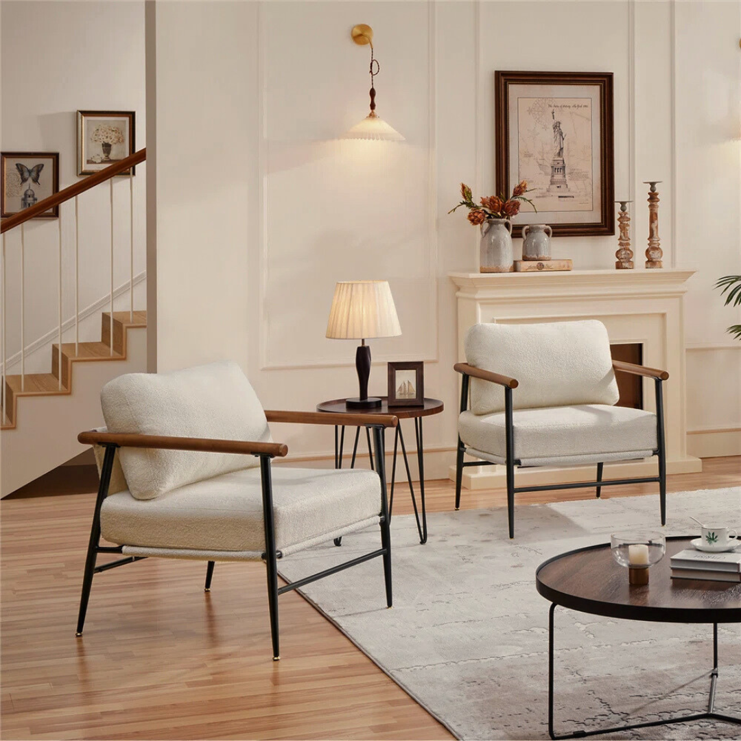 pair of modern white boucle accent chair with wood arms and metal frame, set in a modern living room.