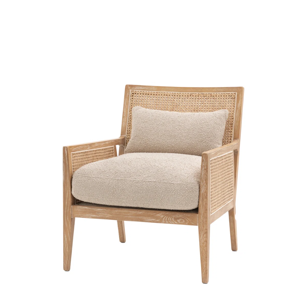 Chair with wicker frame and beige cushion on a white background