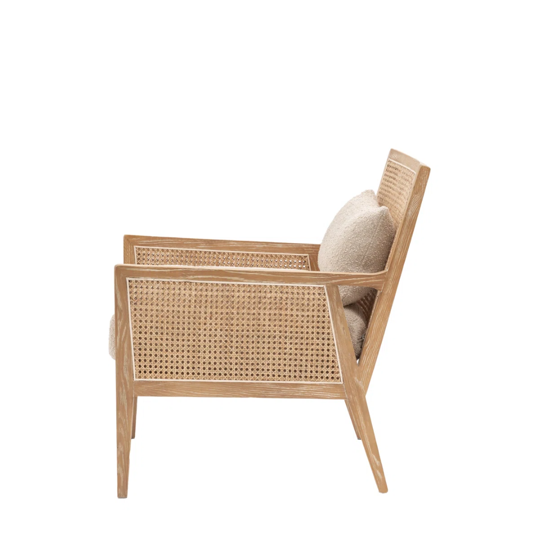 Wicker armchair with woven backrest and cushion on a white background side view