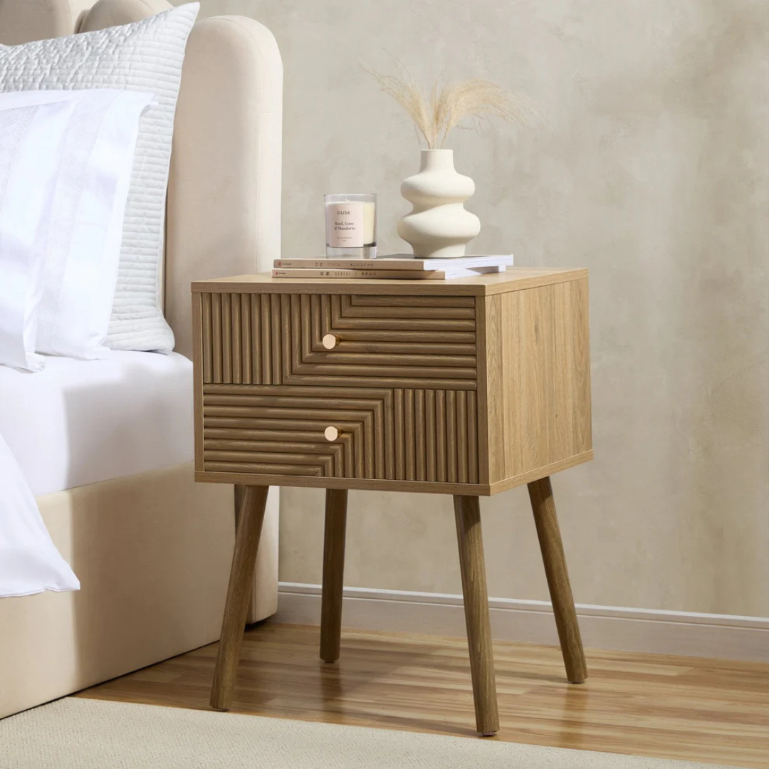 Geometric Mid Century Modern Bedside Table, Wooden nightstand with geometric design next to a bed with white bedding.