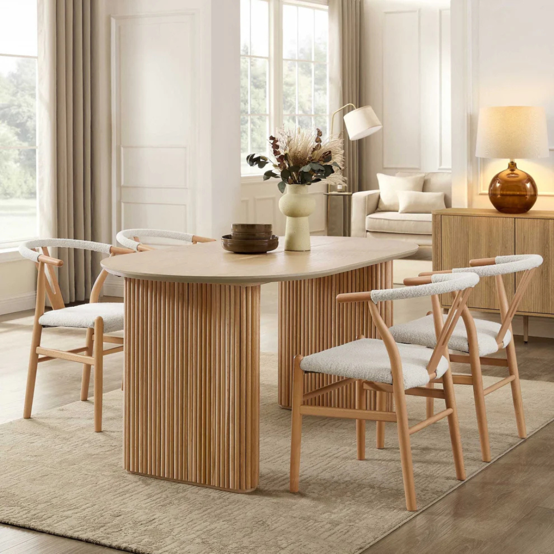 Japandi Wooden Oval Dining Table, set in a modern home with wishbone dining chairs, angled view.