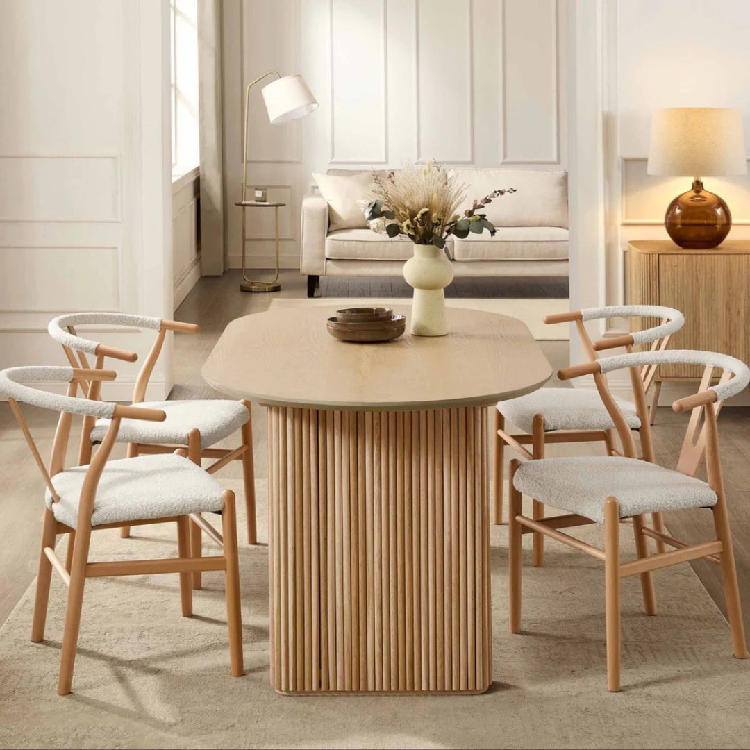 Japandi Wooden Oval Dining Table, set in a modern home with wishbone dining chairs, face view.
