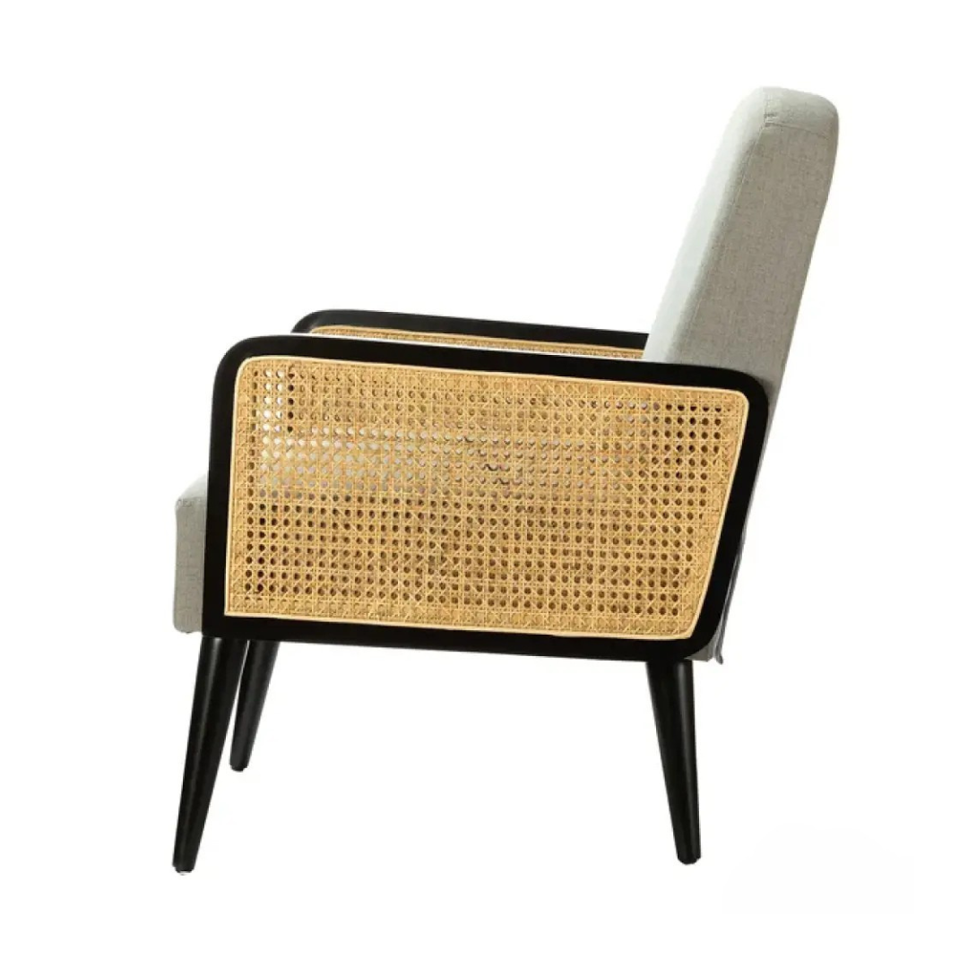 mid century modern black rattan armchair, white background, side view.