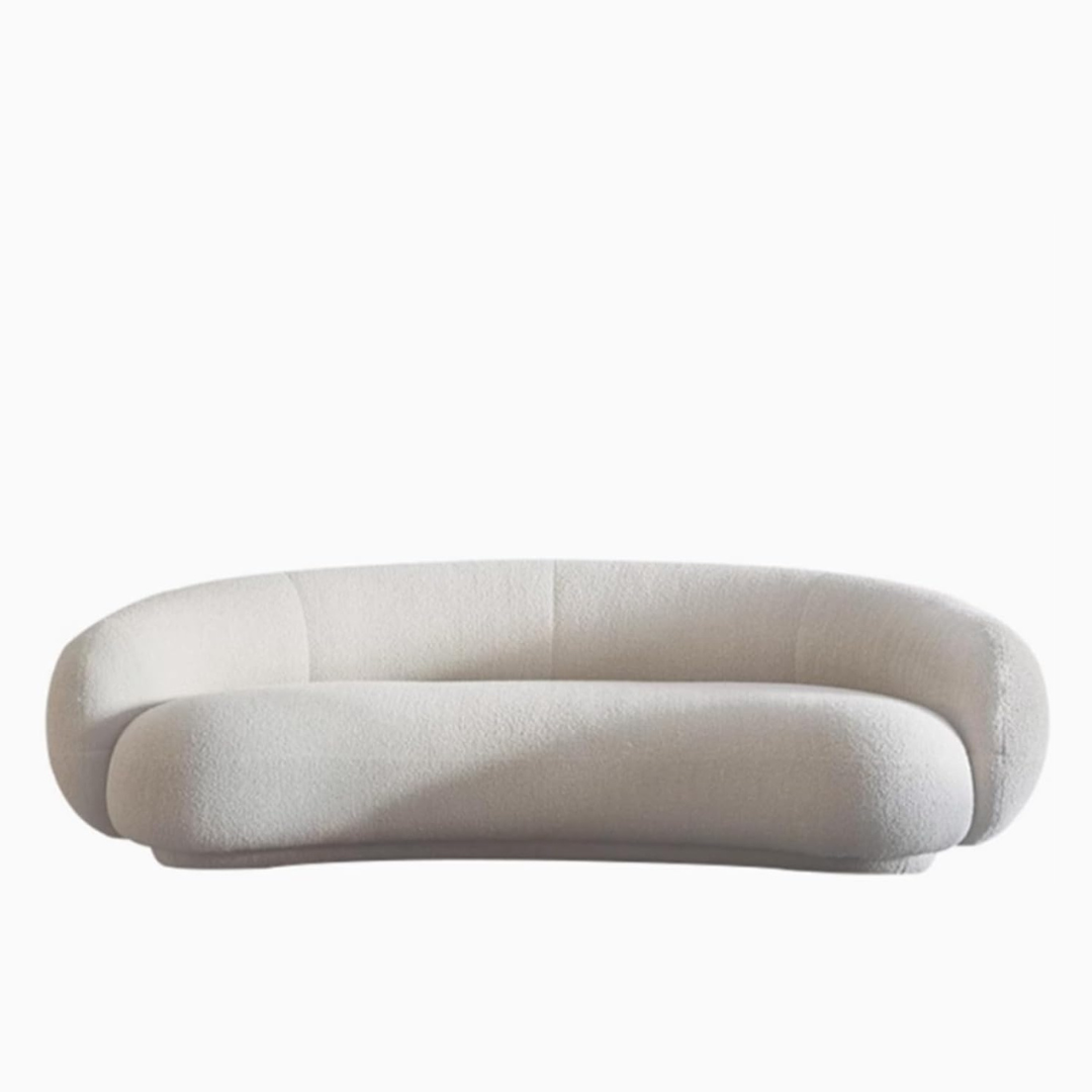 Modern Curved White Boucle Sofa, white background.
