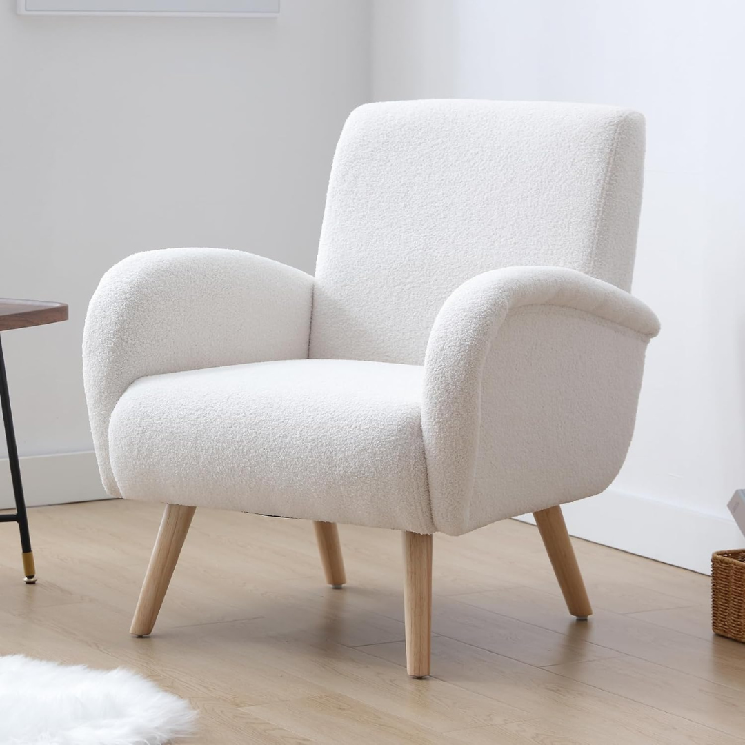 modern faux fur armchair with high back and rounded arms, set up against a white wall.