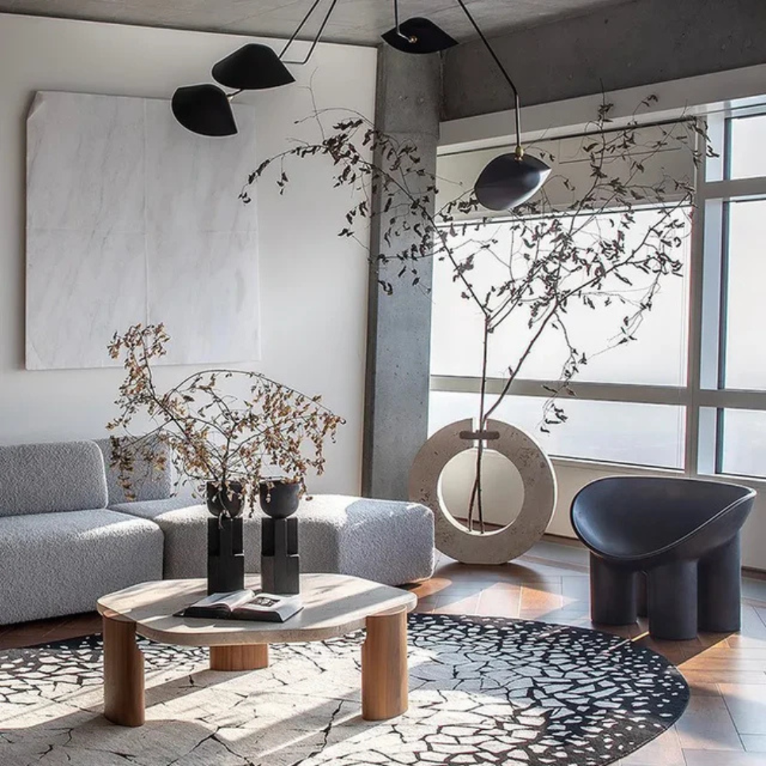 modern marble luxury coffee table with sculpted wood legs, in a modern living space.