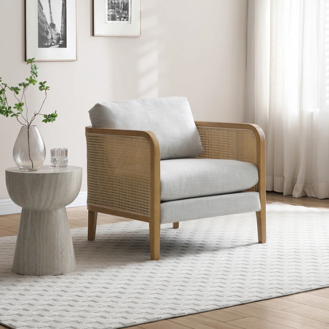 modern rattan armchair with curved wood arms and woven sides, set in a modern living space