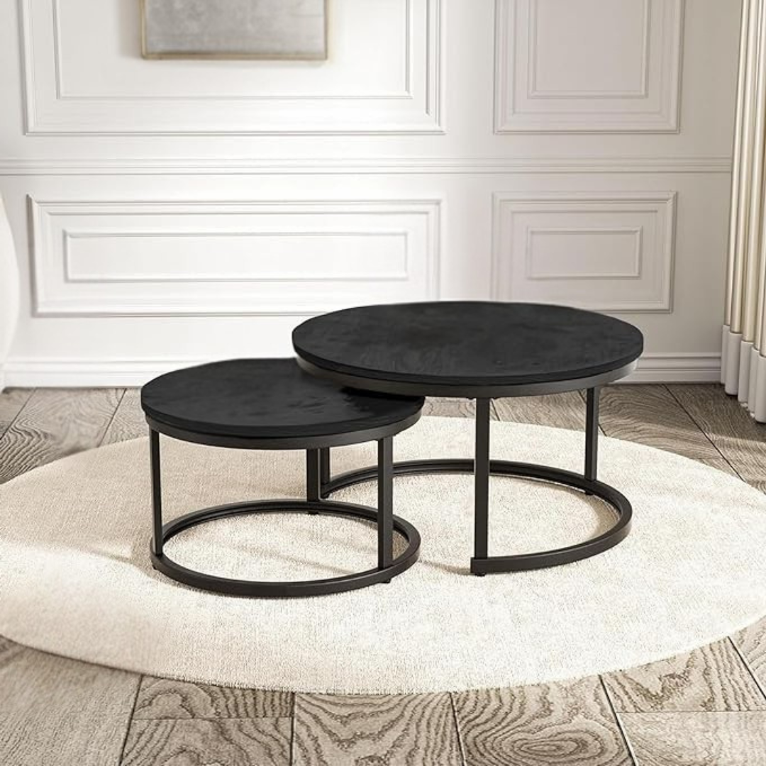 Modern round nesting coffee tables in a living room setting, black.