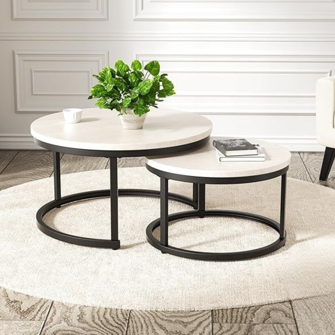 Modern round nesting coffee tables in a living room setting, white.