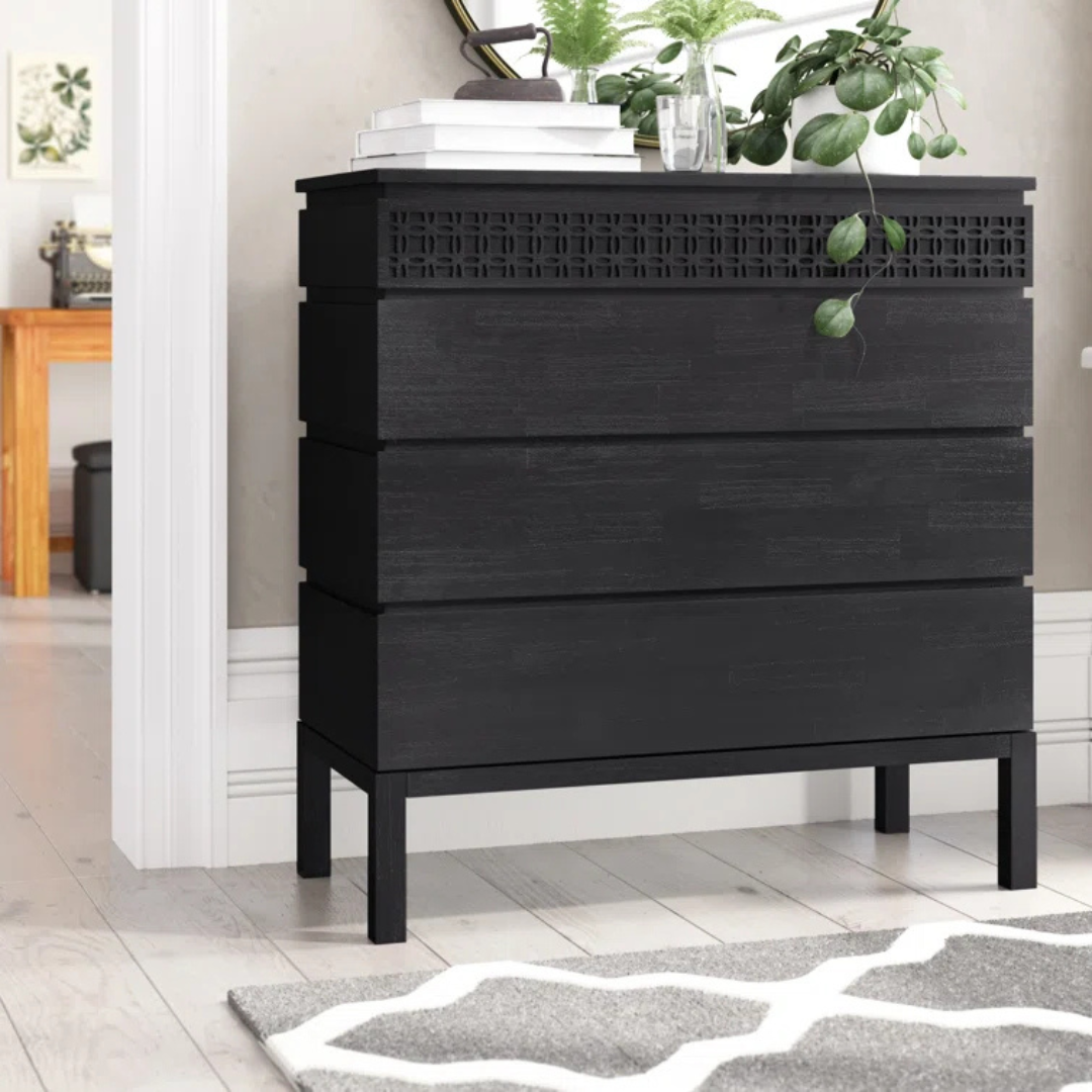Modern Solid Black Wooden Chest Of Drawers, set in a modern home, front view.
