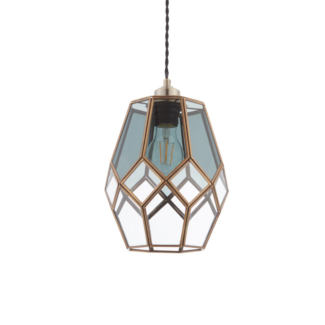 Geometric glass pendant light with brass accents on a white background