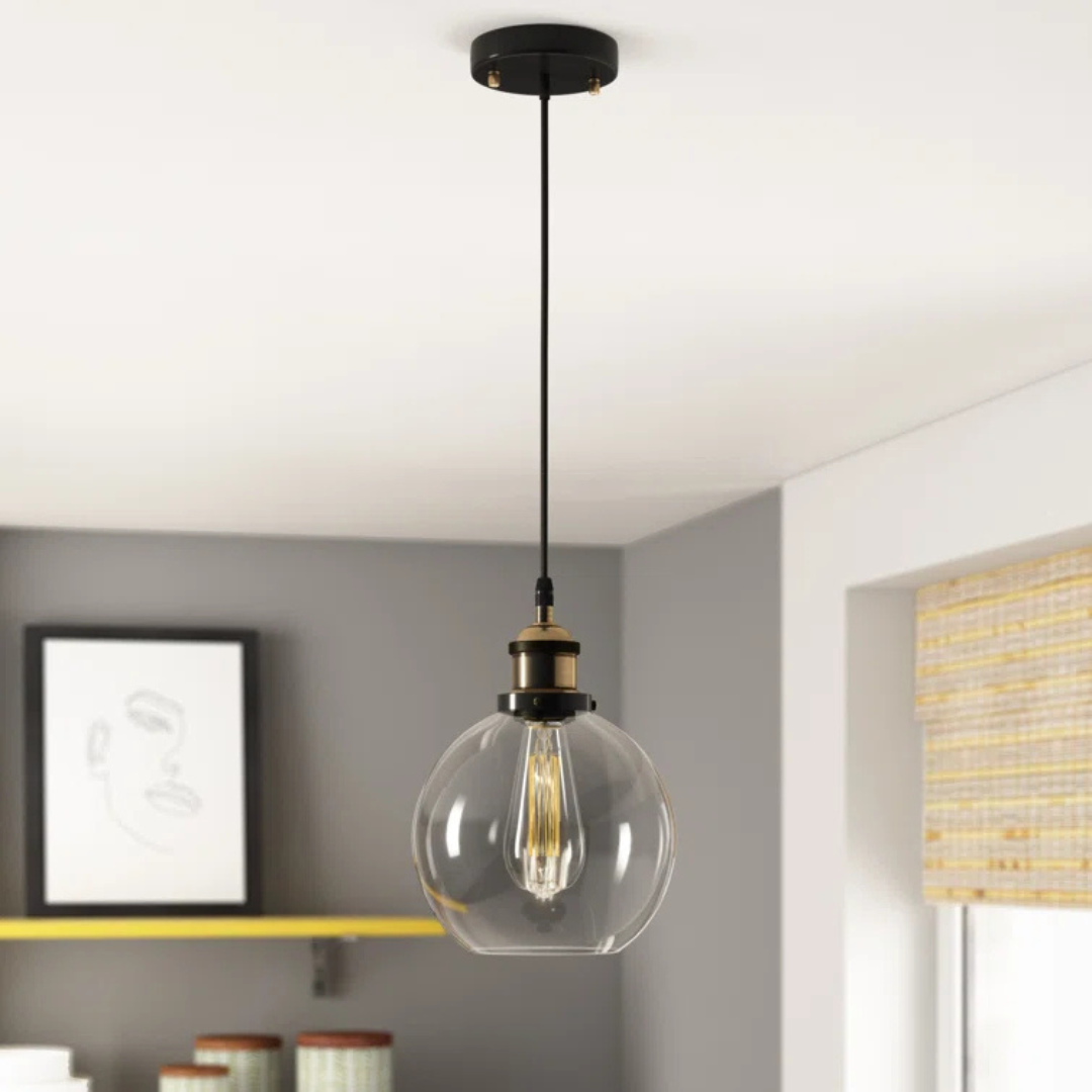 Modern pendant light with clear glass shade in a room setting