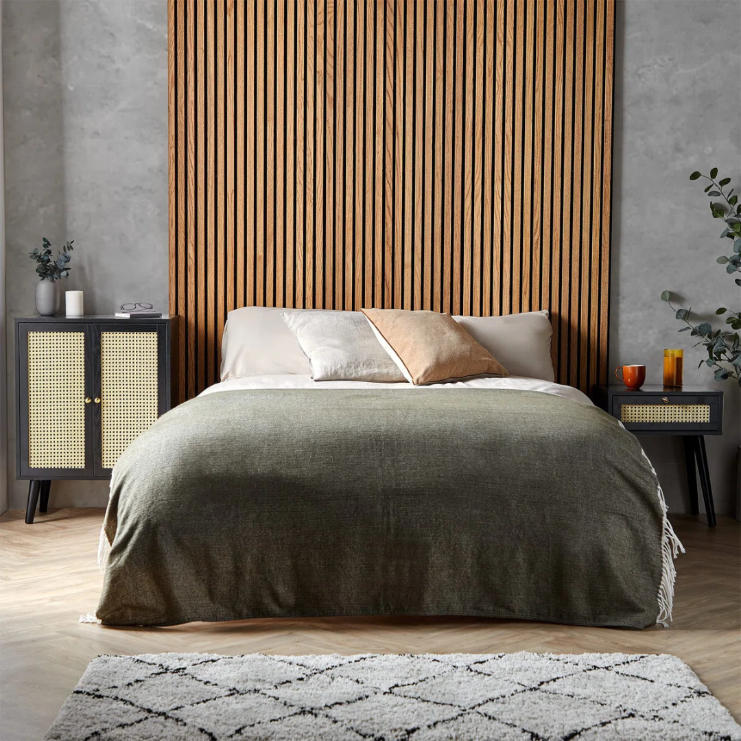 Rattan Black Cabinet Sideboard, set next to a bed in a modern bedroom.