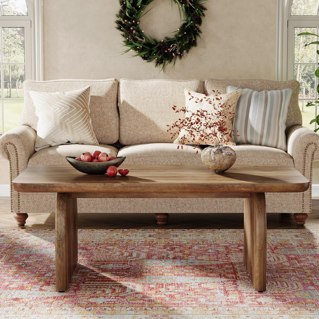 Living room with a beige sofa, wooden coffee table, and decorative items.
