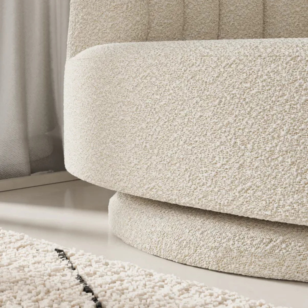 scalloped bouclé swivel chair with fluted backrest design, close up to base of the chair.