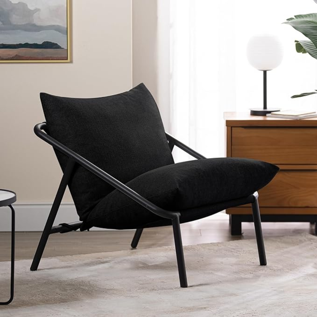 Sling Accent Chair in a modern indoor aesthetic. Black cushions.