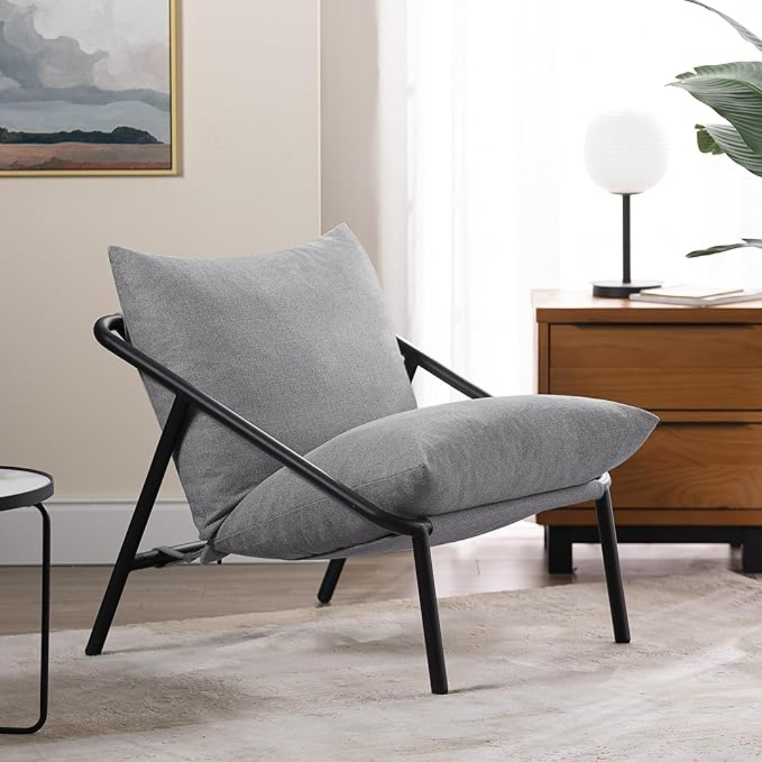 Sling Accent Chair in a modern indoor aesthetic. Light grey cushions.
