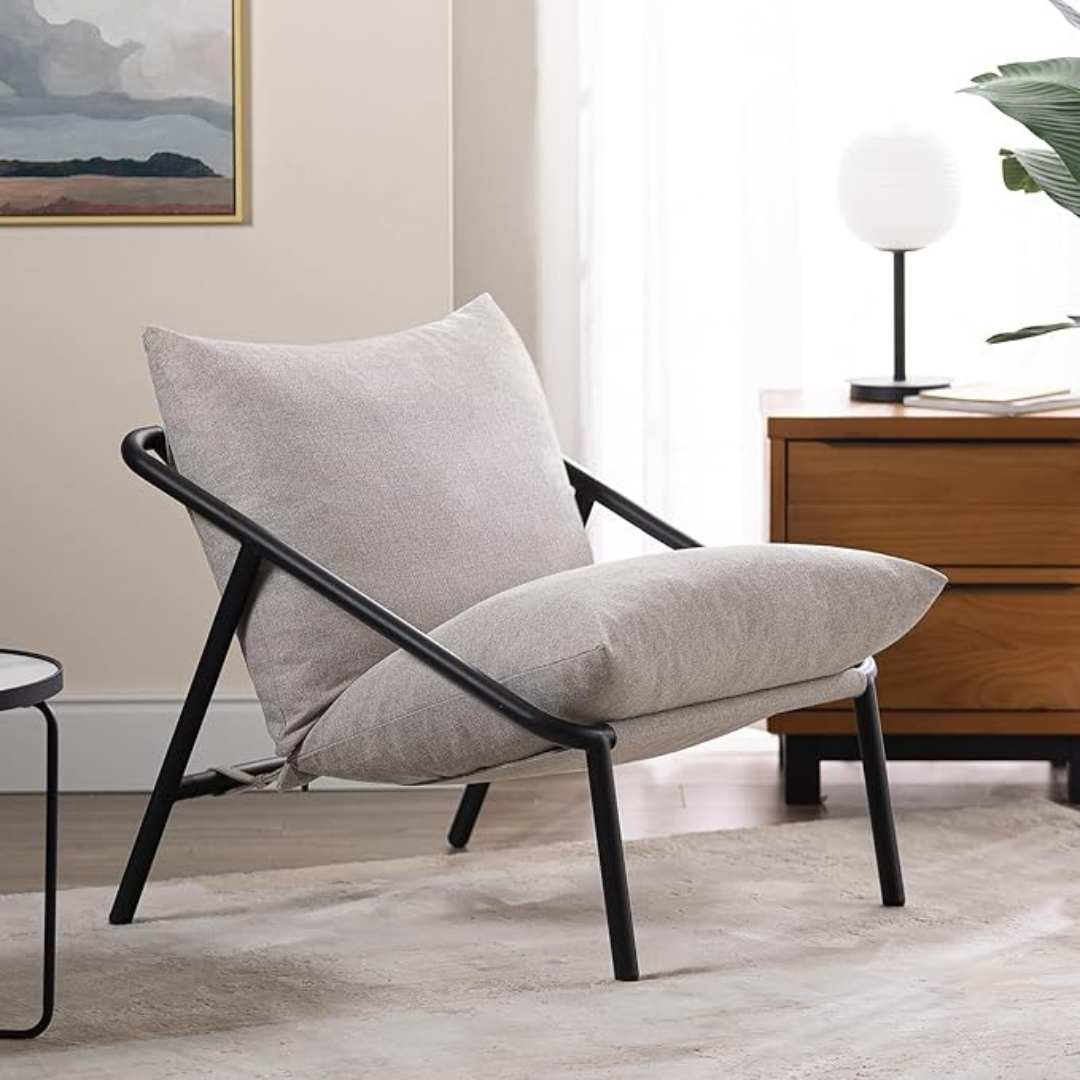 Sling Accent Chair in a modern indoor aesthetic, beige cushions.