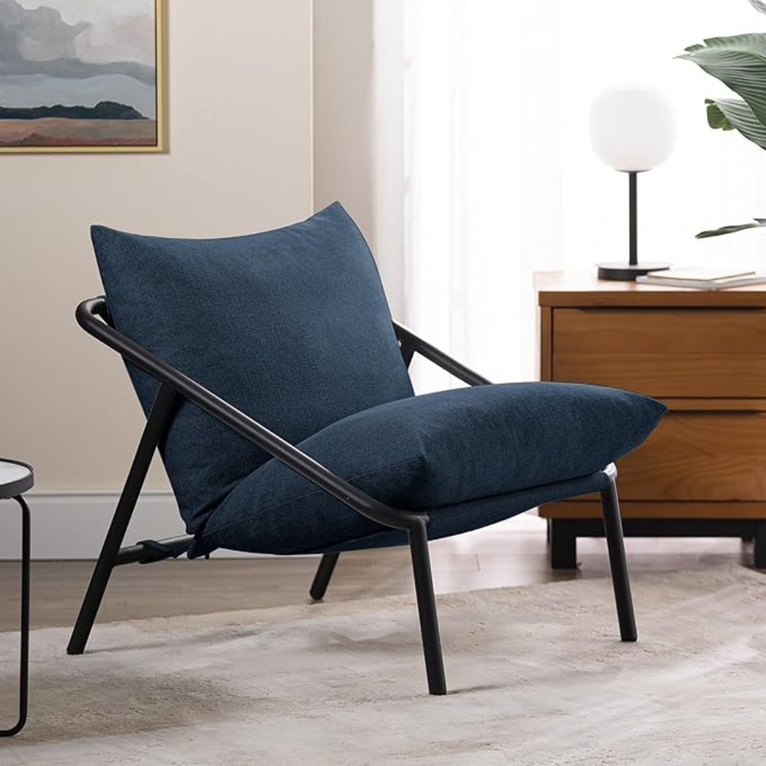 Sling Accent Chair in a modern indoor aesthetic. Navy cushions.