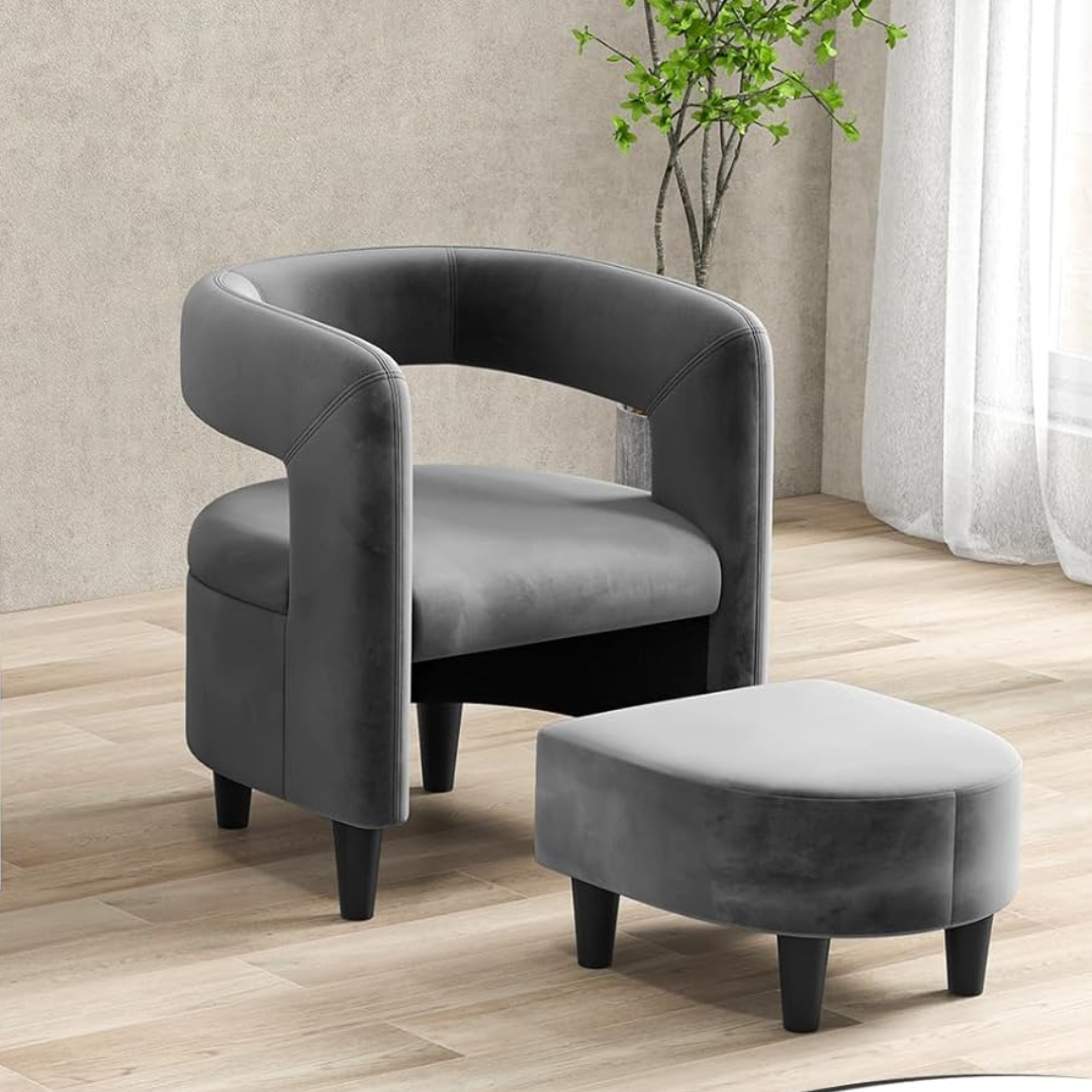 velvet grey accent chair and footstool set with rounded frame, set in a modern living room.