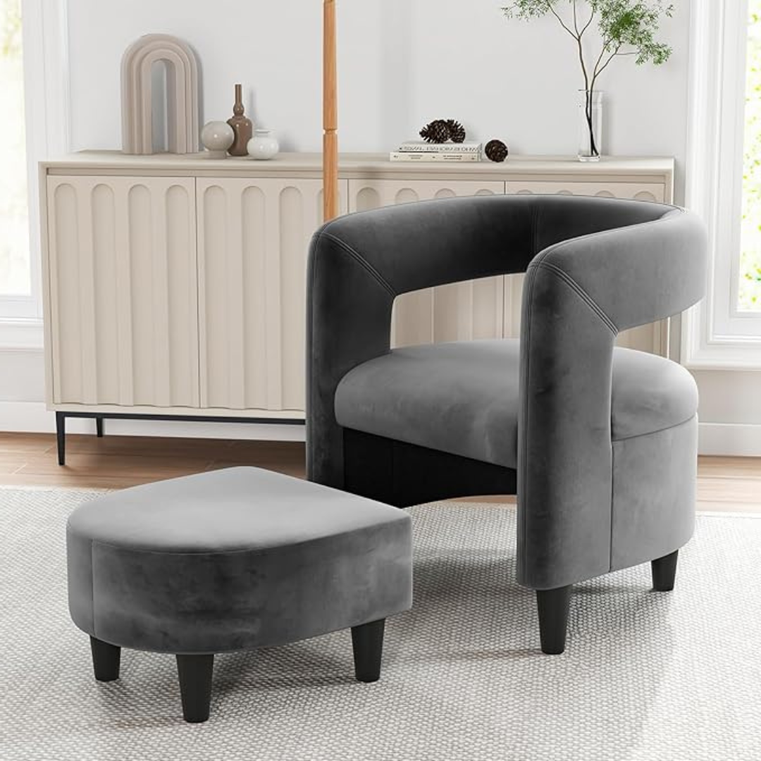 velvet grey accent chair and footstool set with rounded frame, set in a modern home.