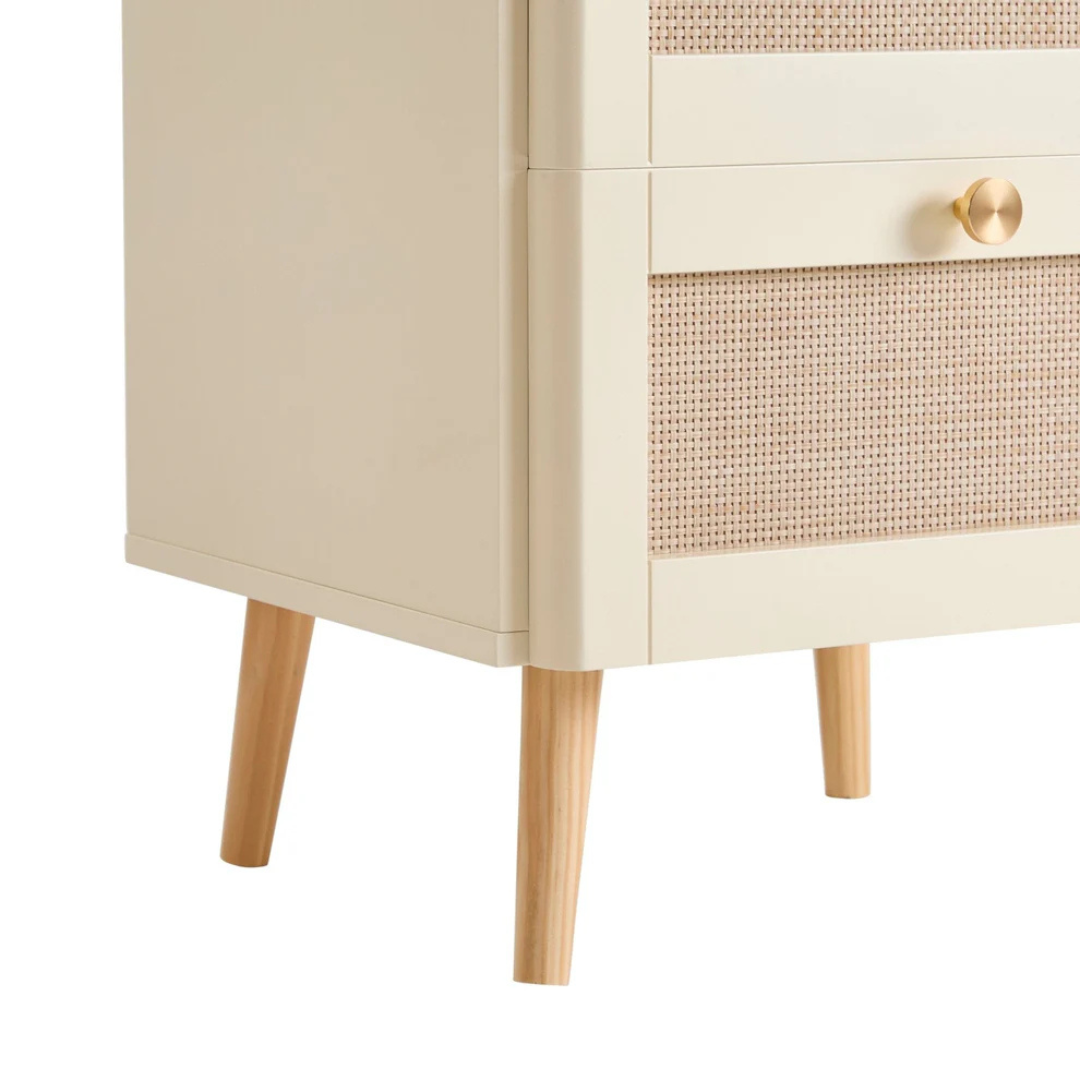 Beige cabinet with rattan door and wooden legs on a white background