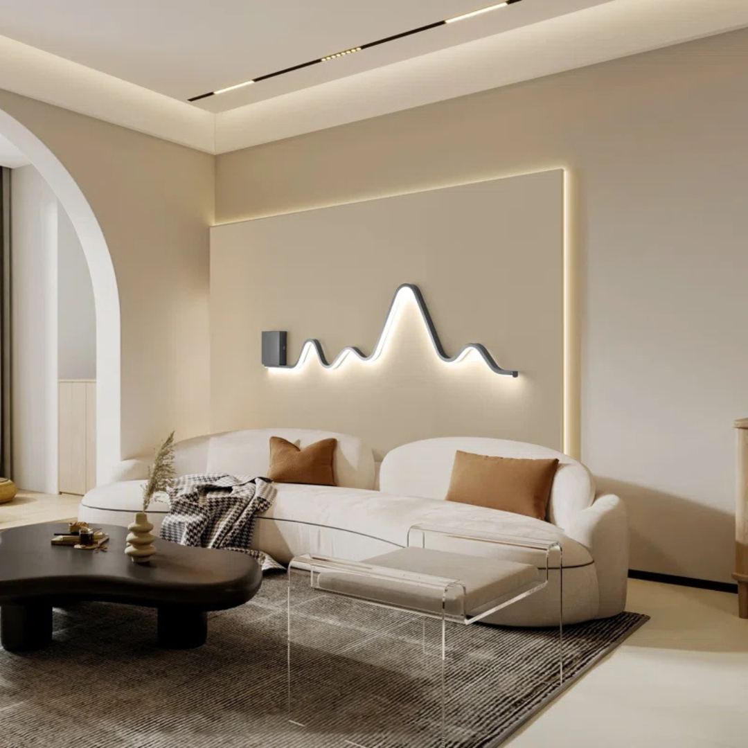 Modern living room with a white sofa, coffee table, and decorative wall light fixture.