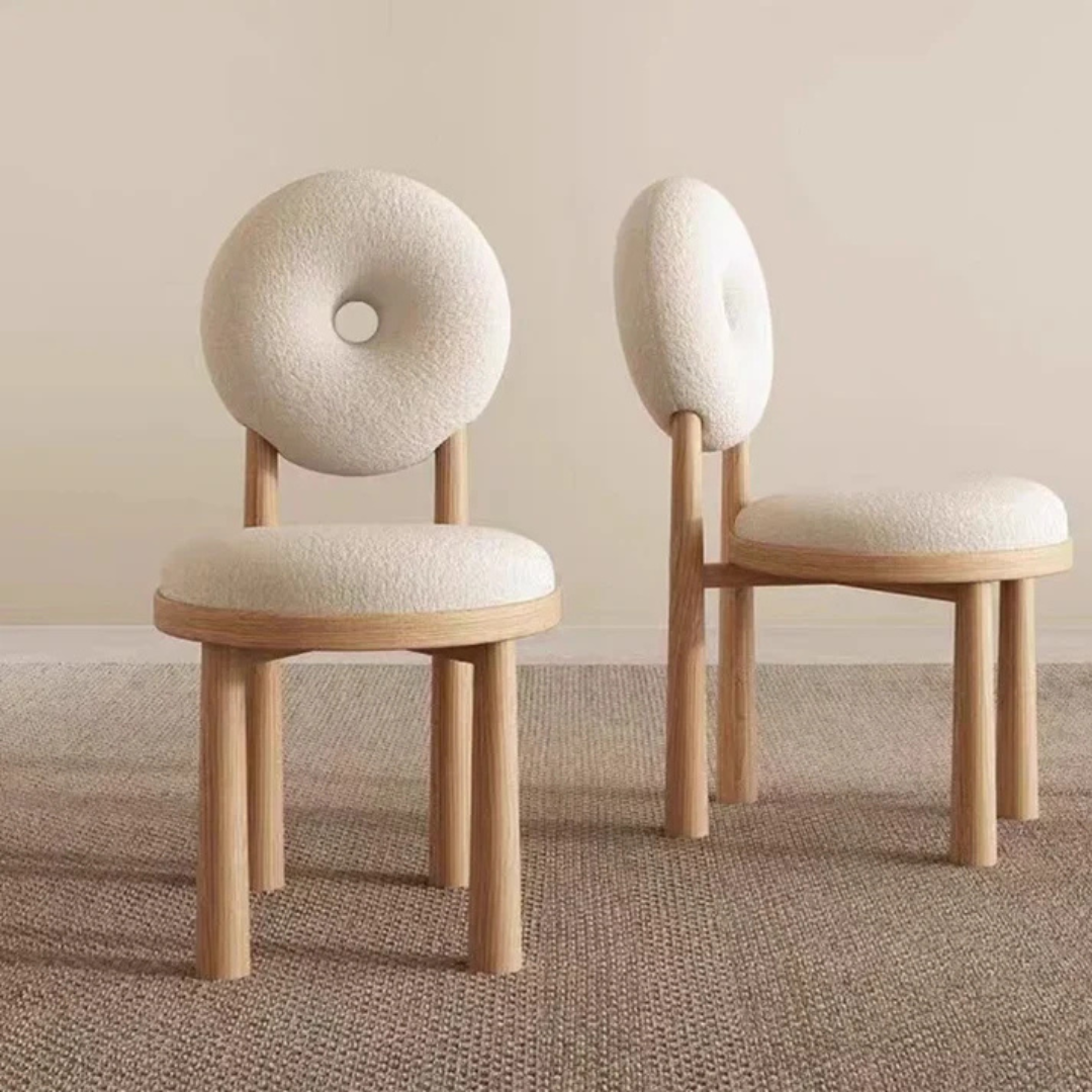 white boucle dining chair with circular back and soft seat, front and side view in a home setting.