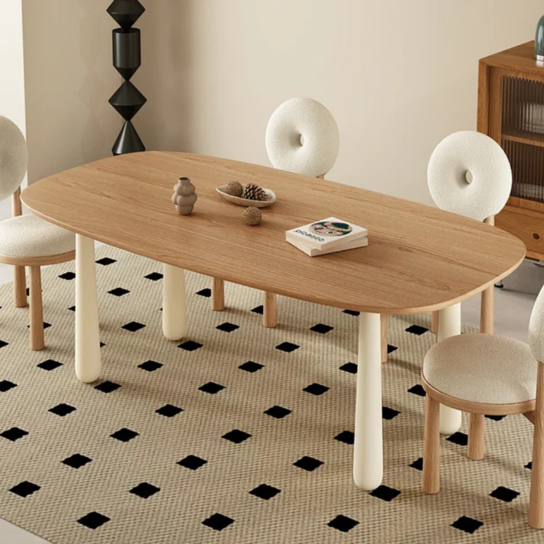 white boucle dining chair with curved back and soft seat, 4 chairs sat around a modern dining room table.