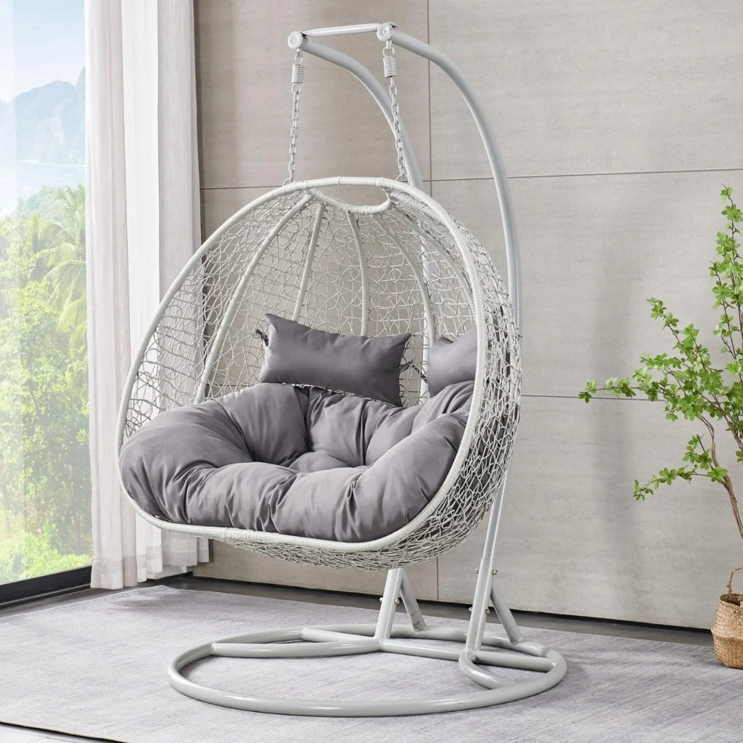 White Double Hanging Egg Chair, angled view, in a modern model home.