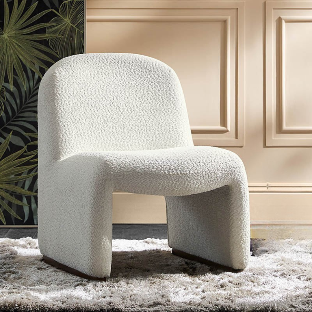 White boucle funky accent chair, set in a mid century modern living room.