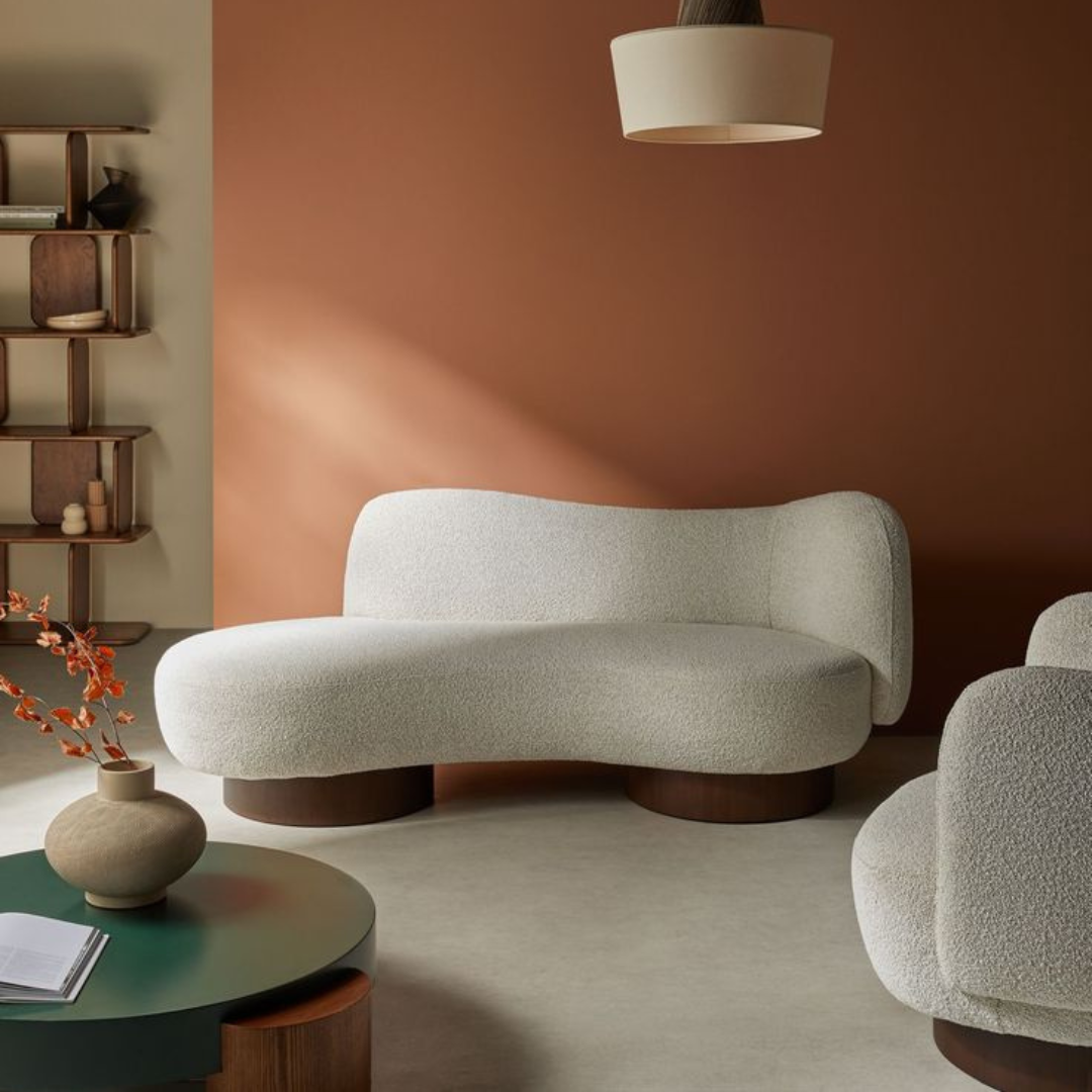 Image shows a luxury boucle 2-seater sofa set in a mid century styled home.