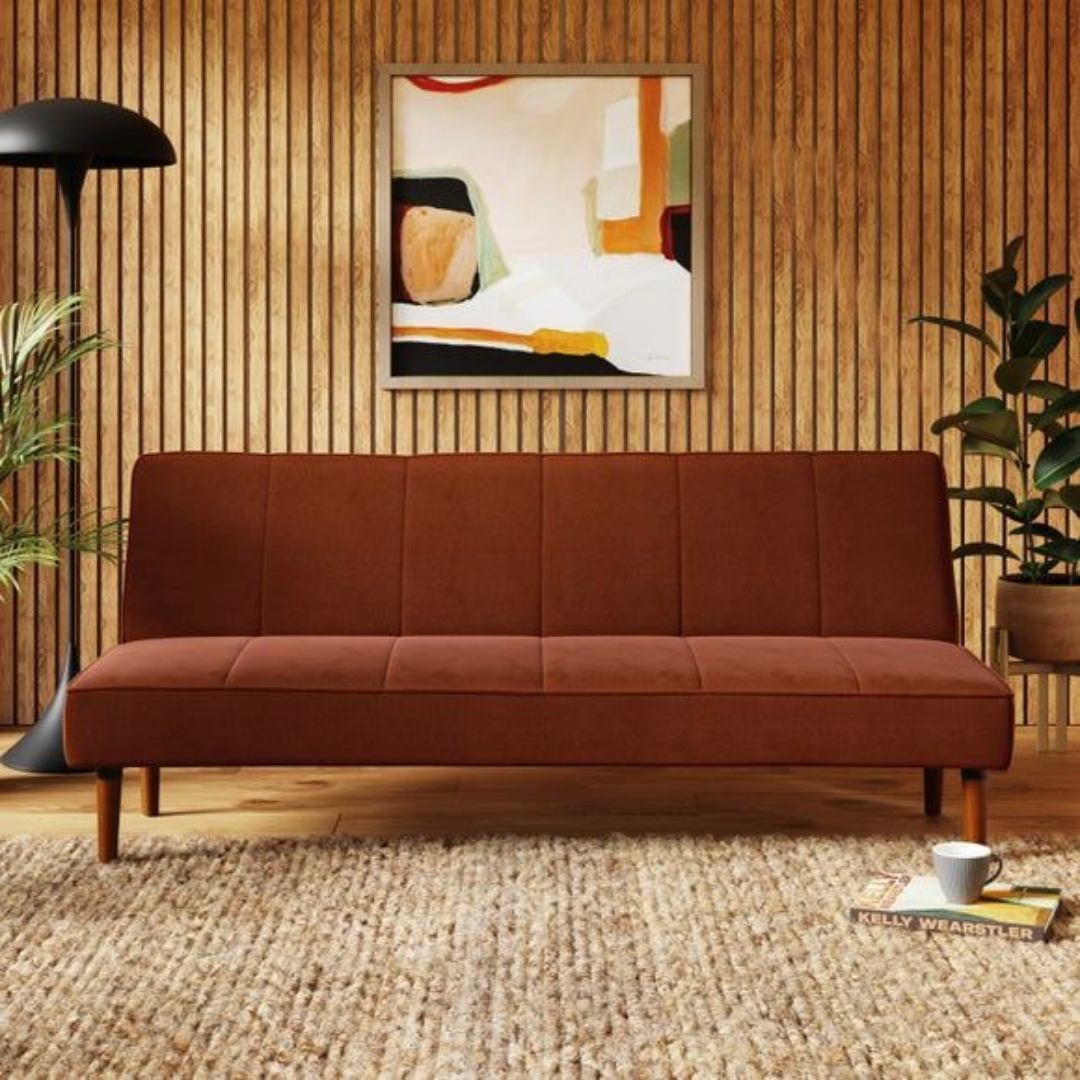 This image shows a vintage brown sofa bed set in a mid century styled home.