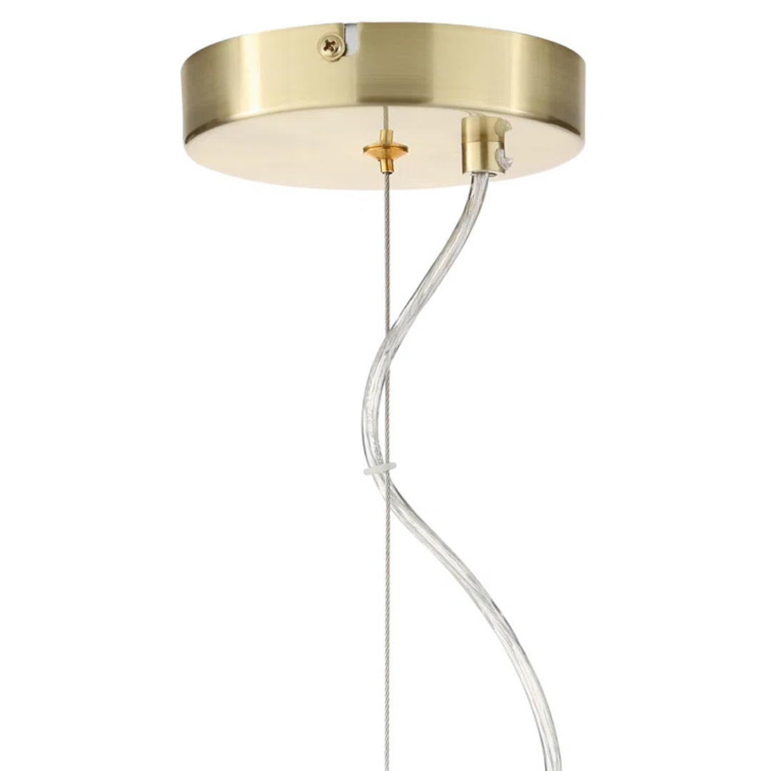 Gold pendant light fixture with clear cable on a white background