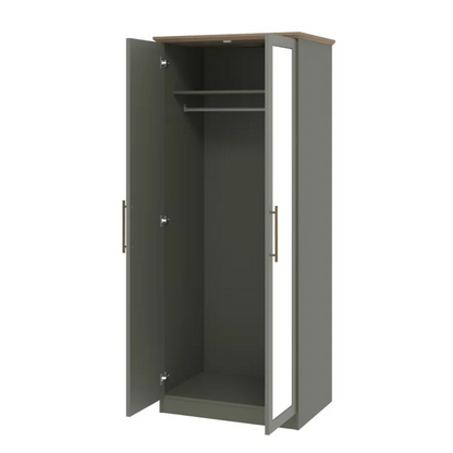 Sage green wardrobe with open doors on a white background
