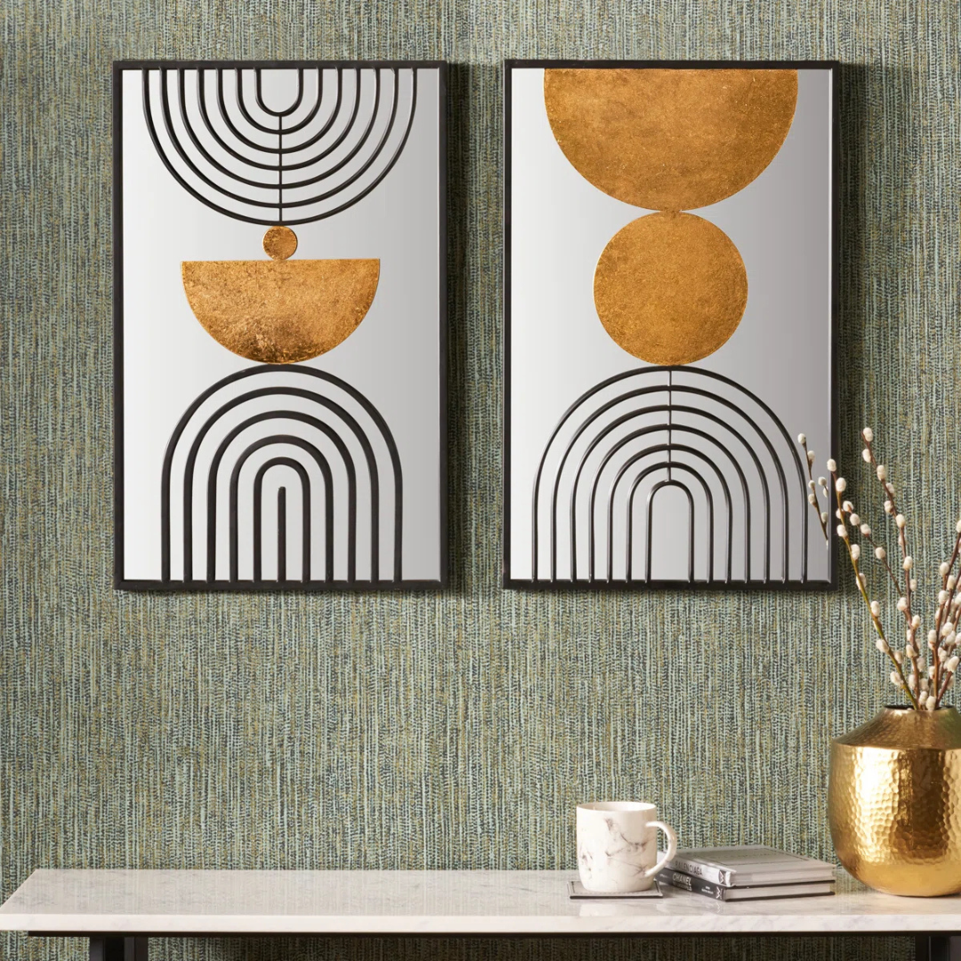 Two abstract wall art pieces with geometric designs on a textured wall.