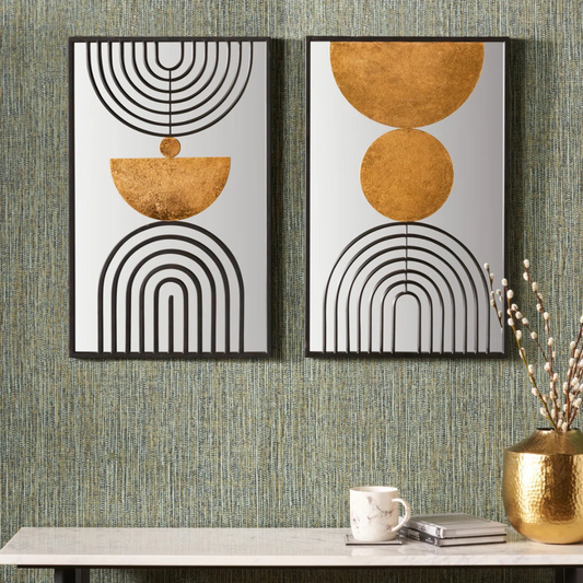 Two abstract wall art pieces with geometric designs on a textured wall.