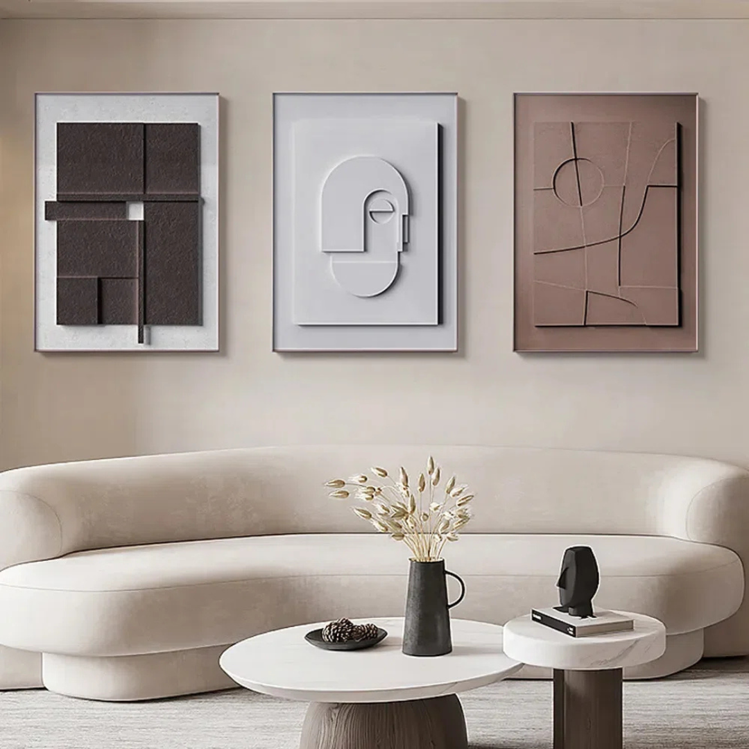 Modern living room with abstract wall art and a beige sofa.