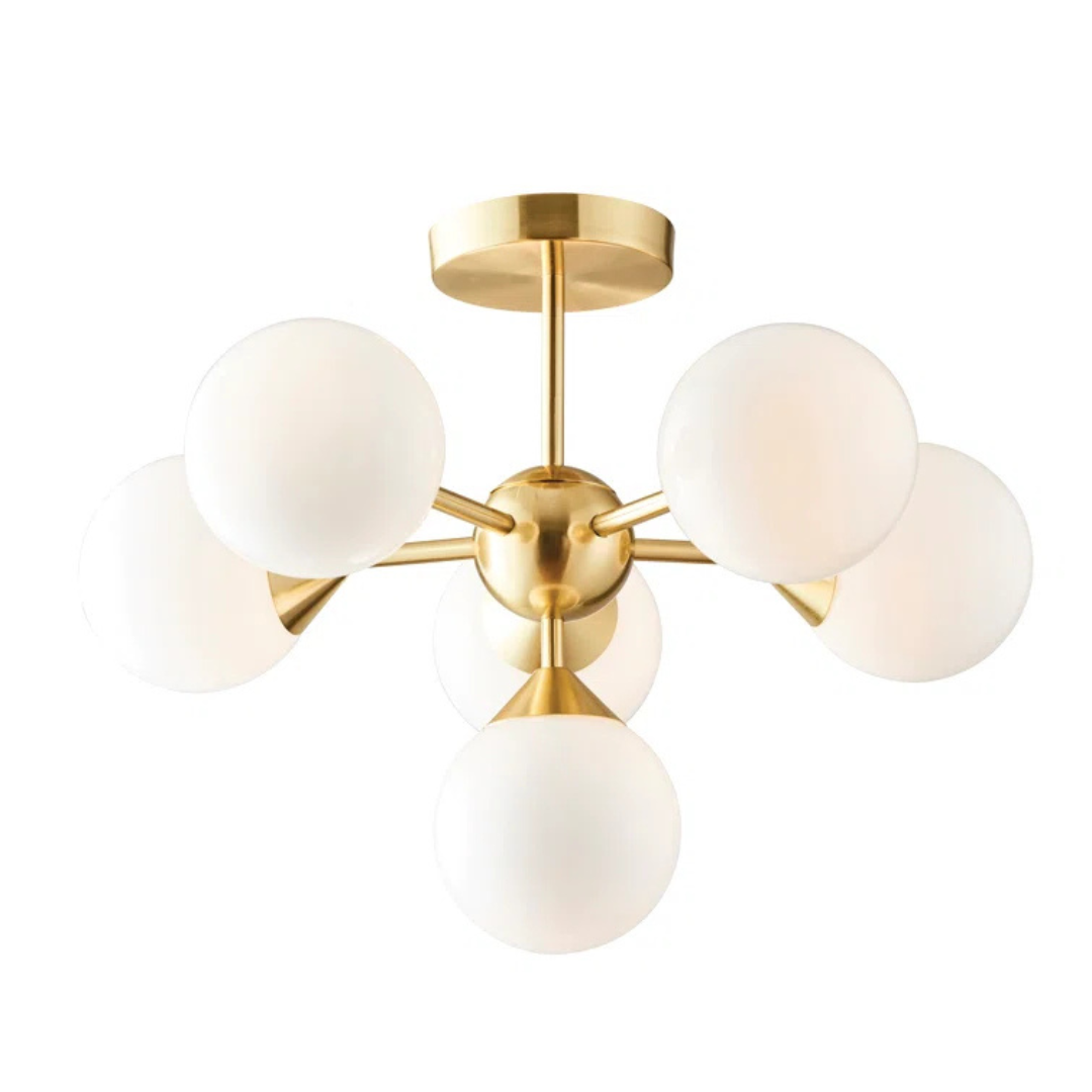 Gold ceiling light fixture with white glass shades on a white background