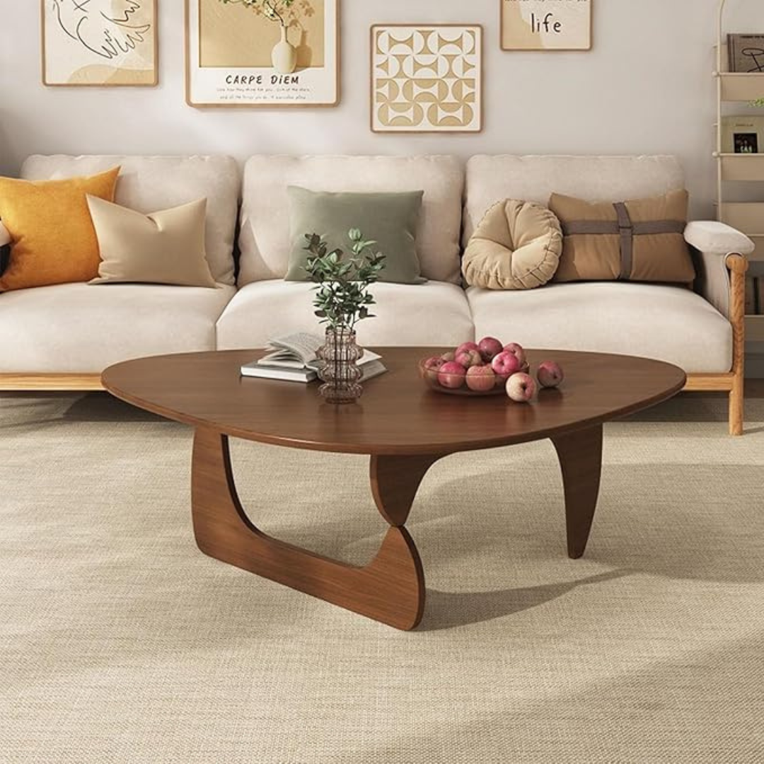abstract mid century coffee table with sculptural wood base, in a modern living room.