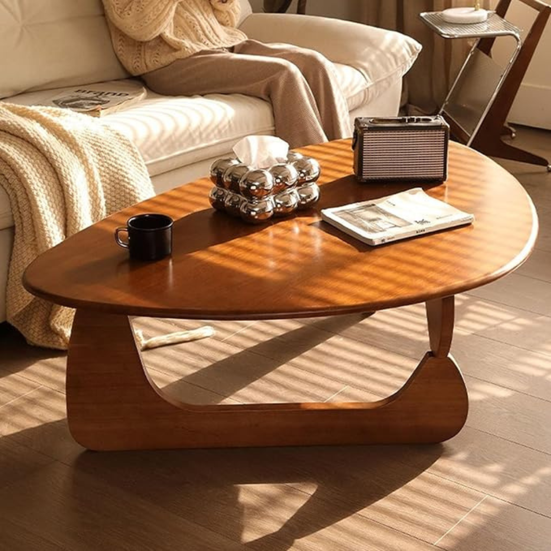 abstract mid century coffee table with sculptural wood base, set infront of a modern sofa.