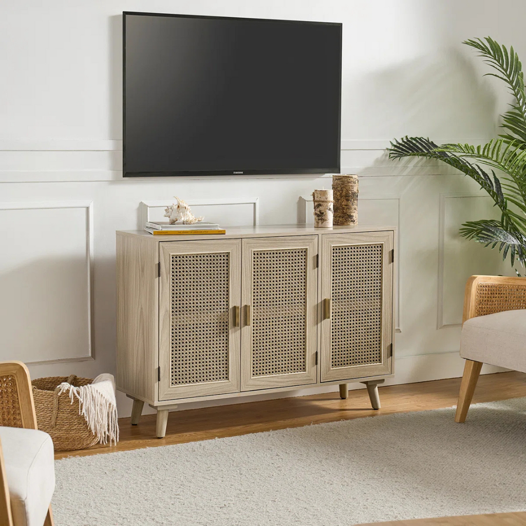 Acorn Rattan Sideboard With Storage, sat under a tv in a modern home.