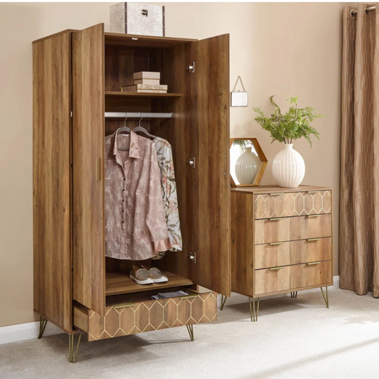 Wooden wardrobe with open doors displaying clothes, next to a matching dresser with decorative items.